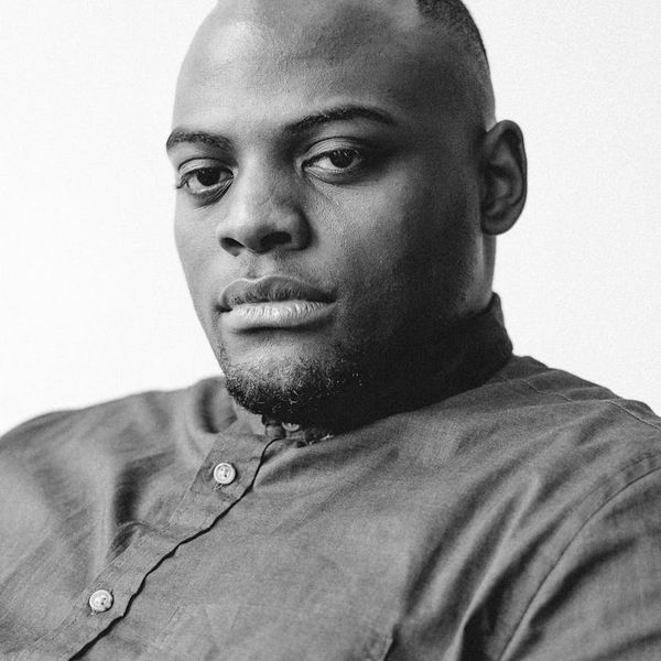 Man in a focused state during a workout, calm expression.